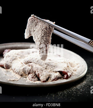 Raw liver sprinkled with flour Stock Photo