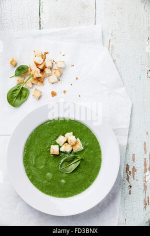 Spinach broccoli soup with croutons in white bowl Stock Photo