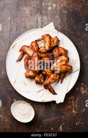 Fried Chicken Wings with sauce on wooden background Stock Photo
