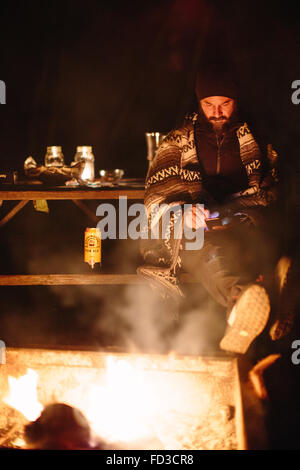 A man sits at the camp fire at night in Big Sur, California. Stock Photo