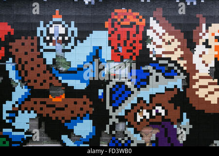 Dragon Quest fans collect blocks from a giant Lego wall mural on January 28, 2016 in Tokyo, Japan. The mural is part of a promotion in Shinjuku Station to celebrate the release of new game Dragon Quest Builders. The 80 meter mural was made with 180,000 Lego blocks and fans were allowed to remove blocks to reveal a secret poster behind. Some blocks contained QR codes allowing fans to access exclusive content. © Rodrigo Reyes Marin/AFLO/Alamy Live News Stock Photo