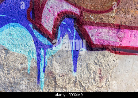 Hooligan smeared paint the walls of the old building. Landscape style. Grungy concrete surface with cracks, scratches and streak Stock Photo