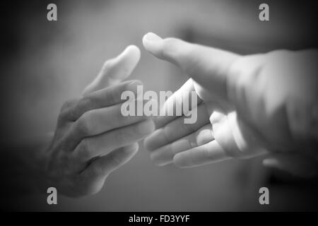 Caucasian boy offering a helping hand to elder Stock Photo