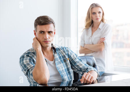 Upset man and woman having difficulties and problems in relationships Stock Photo