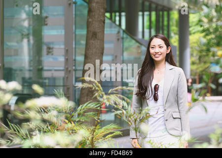 Japanese attractive businesswoman in downtown Tokyo Stock Photo