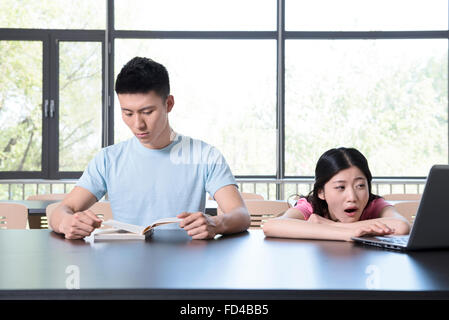 Young couple in library Stock Photo