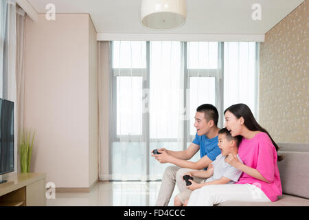 Young family playing video game Stock Photo