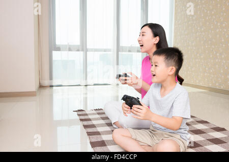 Mother and son playing video games Stock Photo