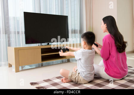 Mother and son playing video games Stock Photo