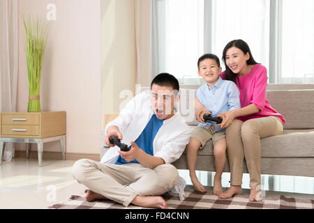 Young family playing video game Stock Photo