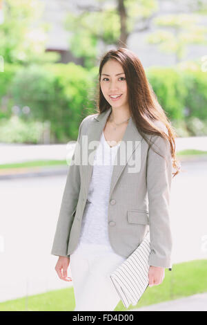 Japanese attractive businesswoman in downtown Tokyo Stock Photo