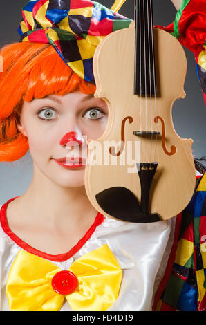 The clown in funny concept on dark background Stock Photo