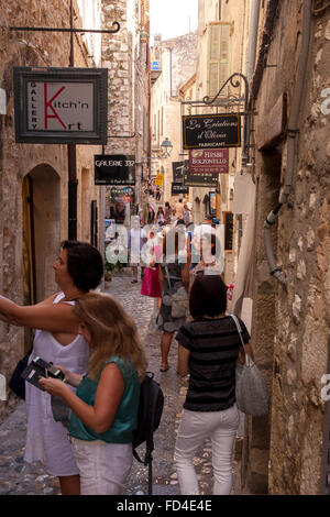 Tourists in the town centre of the bustling visitor destination St Paul de Vence, near Nice France. Stock Photo