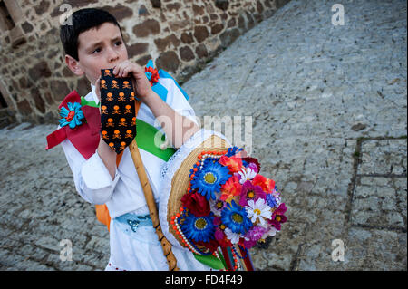 A child with white dress tie Zamarron manages to participate in the carnival of Polaciones Stock Photo
