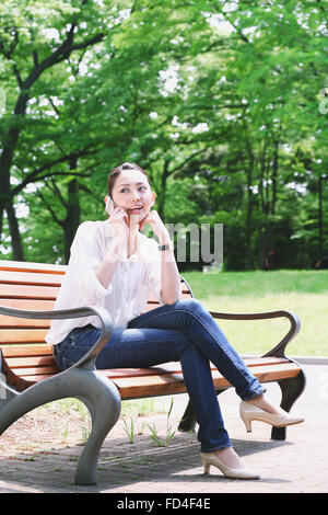 Japanese attractive woman in a city park Stock Photo