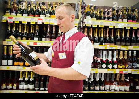 Morrisons supermarket. A man works in the wine section Stock Photo