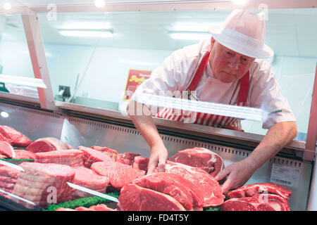 Morrisons supermarket. A man works on the butcher counter Stock Photo