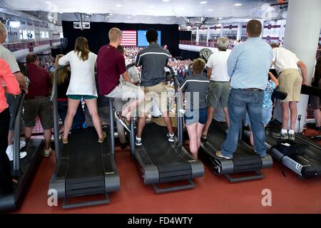 Audience members standing on treadmills as they listened to U.S President Barack Obama make remarks at the University of Wisconsin July 2, 2015 in La Crosse, Wisconsin. Stock Photo