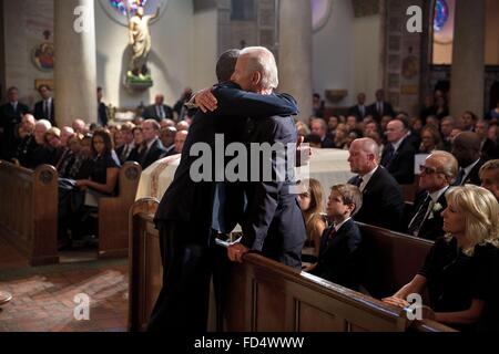 U.S. President Barack Obama hugs Vice President Joe Biden after delivering a eulogy during the funeral mass for Beau Biden at St. Anthony of Padua Catholic Church June 6, 2015 in Wilmington, Delaware. Stock Photo