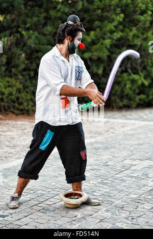 A clown making balloons in the streets of Athens, Greece Stock Photo