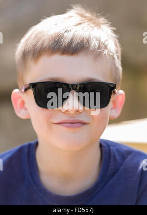 Young boy wearing sunglasses outdoor portrait  Model Release: Yes.  Property Release: No. Stock Photo