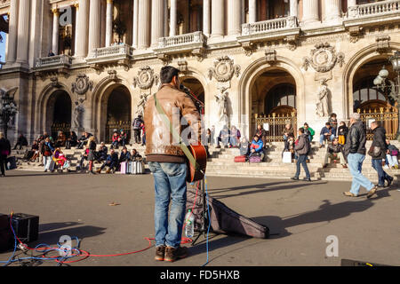 Street musician playing in front of the Palais Garnier, Opera House in Paris, France. Stock Photo