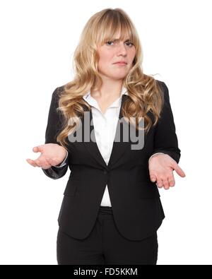 Young businesswoman shrugging her shoulders in ignorance, to show she does not know the answer and could not care. Stock Photo