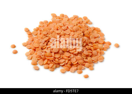 Heap of dried red lentils on white background