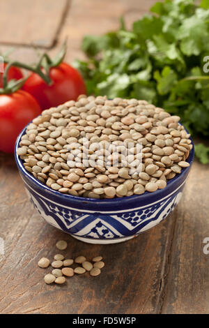 Dried Brown lentils in a bowl Stock Photo