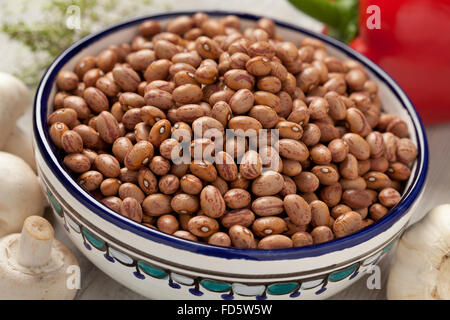 Dried Borlotti beans in a bowl Stock Photo