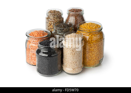 Variety of dried lentils in glass pots on white background Stock Photo