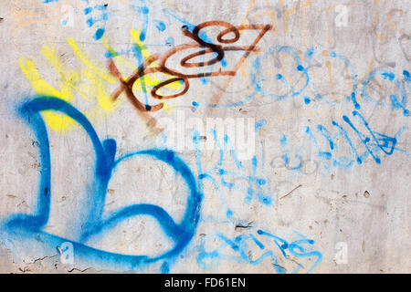Hooligan smeared paint the walls of the old building. Landscape style. Grungy concrete surface with cracks, scratches and streak Stock Photo
