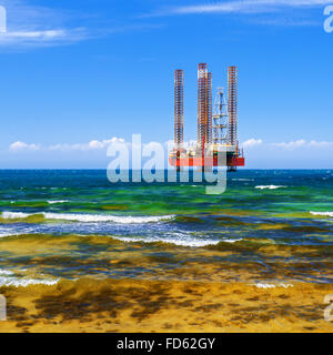 Offshore oil and Gas Production. Drilling platform in the sea against a blue sky