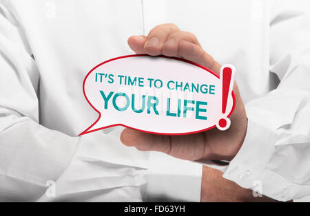 Image of a man hand holding speech bubble with the text it is time to change your life, white shirt. Conceptual message for moti Stock Photo
