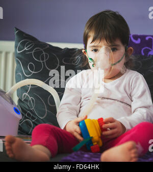 girl making inhalation with mask on her face Stock Photo