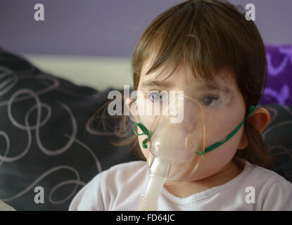 girl making inhalation with mask on her face Stock Photo