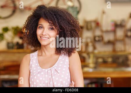 Beautiful mixed race woman smiling in a coffee shop Stock Photo