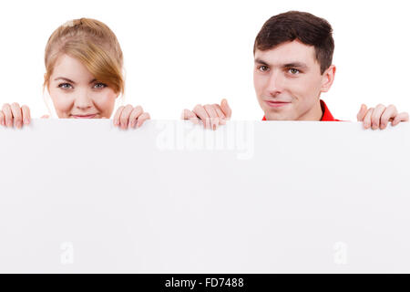Couple with blank presentation board. Woman and man showing banner sign billboard copy space for text. Advertisement concept. Stock Photo
