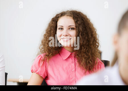Young people sitting in classroom at lesson Stock Photo