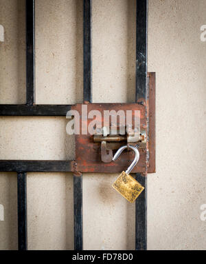 Large metal gate and open padlock on a burglar prevention door in Botswana, Africa Stock Photo