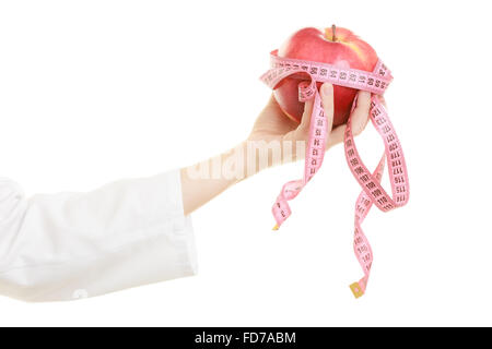 Slim down dieting concept. woman in white lab coat recommending healthy food. Doctor specialist dietitian holding fruit apple. Stock Photo