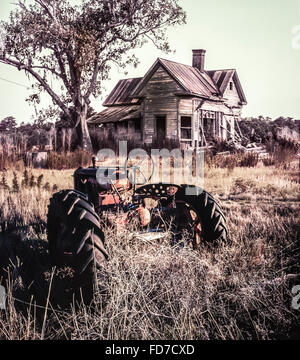 dilapidated farm equipment and abandoned home in ruin Stock Photo