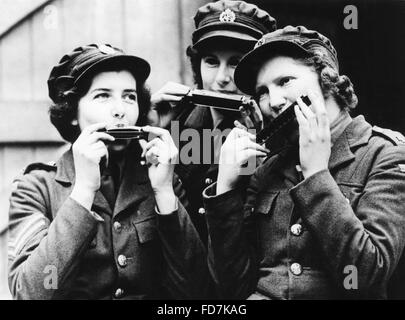 Women of the Auxiliary Territorial Service (ATS) in France playing harmonica, 1939 Stock Photo