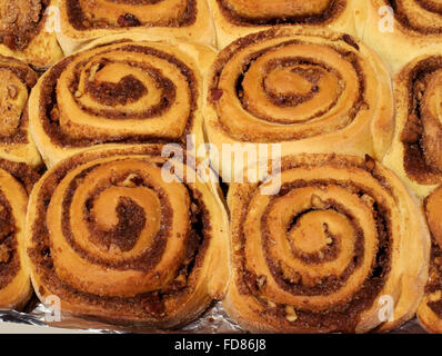 Baked cinnamon buns with sugar and pecan nuts Stock Photo