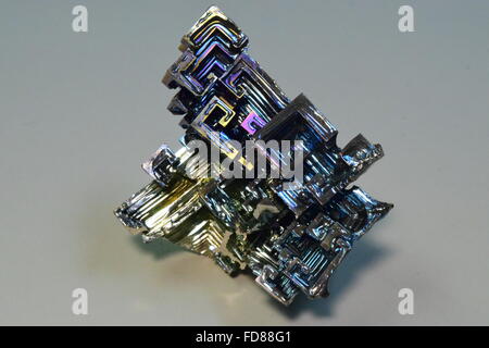 Bismuth metal crystals exhibiting cubic 'hopper growth', and tarnished as a result of air oxidation. Stock Photo