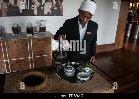 A tea boy a member of the hotel staff,  serving locally grown tea at the 4-star Heritance Tea Factory hotel above Nuwara Eliya in the Central Province of Stock Photo
