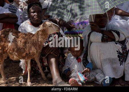 Orthodox church gathering with local people sitting in the shade with their offerings for the priests in Ethiopia. Stock Photo