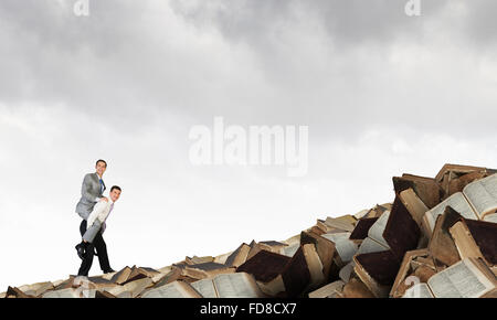 Businessman riding on back of his colleague Stock Photo