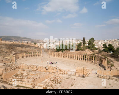 Oval Forum and Cardo of Jerash Roman city with the new city in background Stock Photo