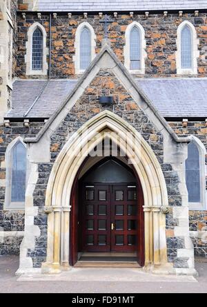 Entry into the unknown church with wooden doors. Stock Photo